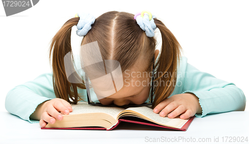 Image of Little girl is sleeping on a book