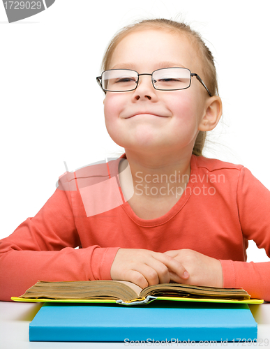 Image of Cute little girl reading book