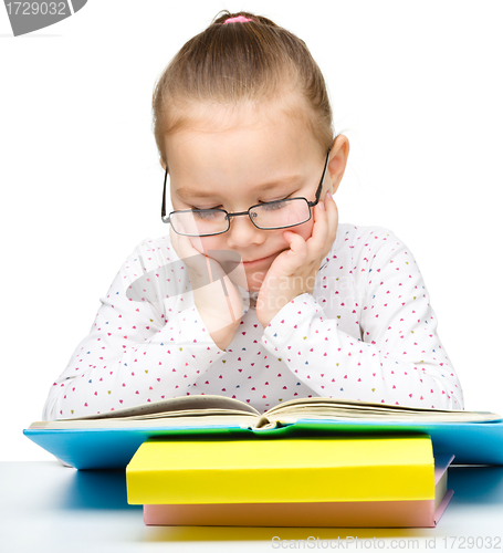 Image of Cute little girl reading book