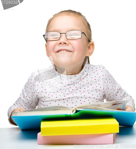Image of Cute little girl reading book