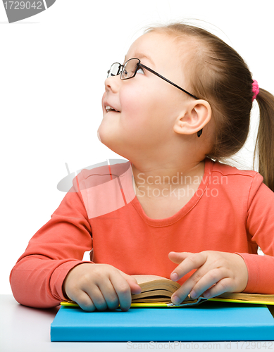 Image of Cute little girl reading book