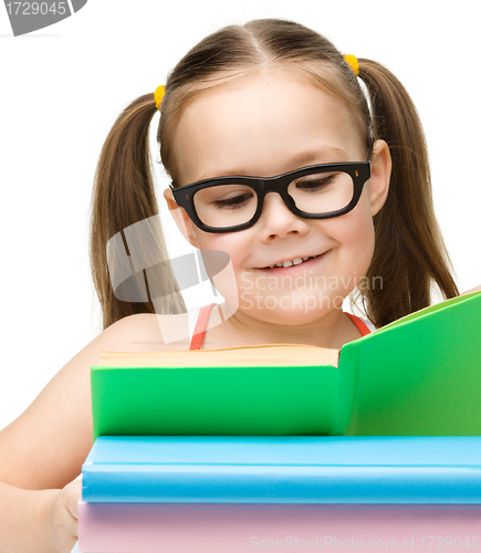 Image of Cute little girl with books