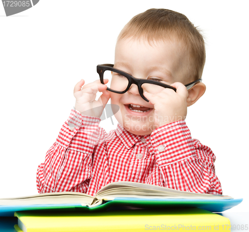 Image of Little child play with book