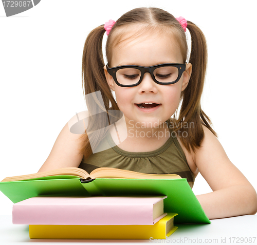 Image of Cute little girl reading book