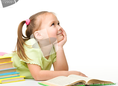 Image of Cute little girl with books
