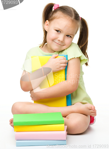 Image of Cute little girl with books