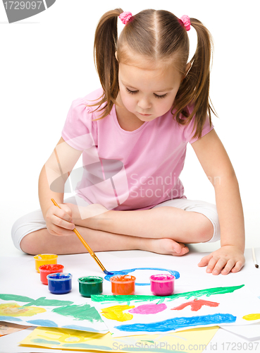 Image of Cute cheerful child play with paints