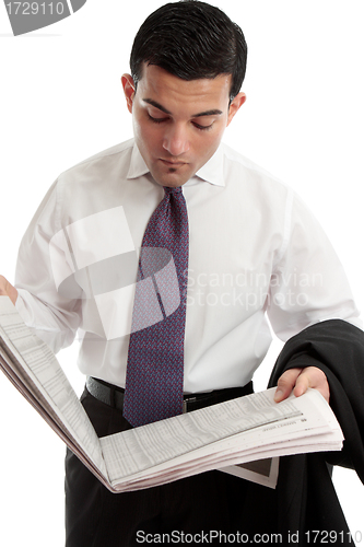 Image of Businessman reading stocks and shares prices in newspaper