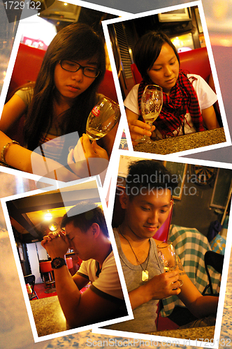 Image of Asian people drinking wine in bar