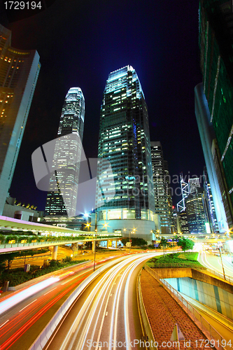 Image of Traffic in city at night, it shows the busy business environment