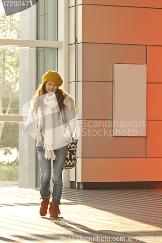 Image of Asian stylish girl in train station walking