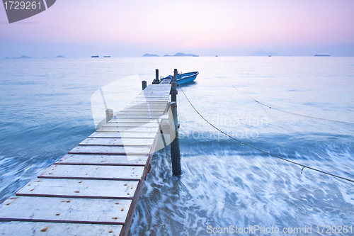 Image of Jetty sunset along coast with waves movement