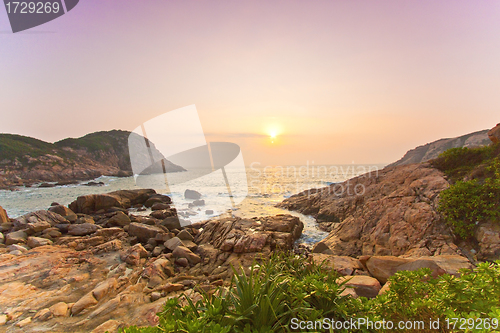 Image of Sea rocks along the coast under sunrise
