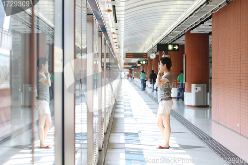 Image of Asian girl waiting in train station