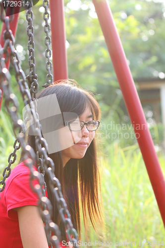 Image of Asian girl smiling in a park