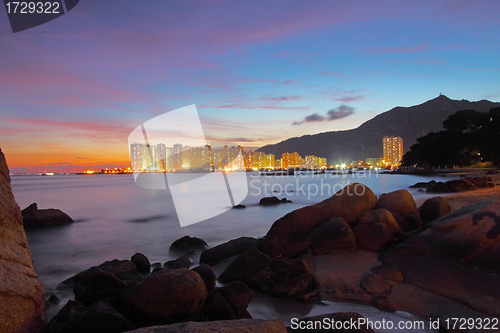 Image of Sunset along seashore with long exposure of sea stones