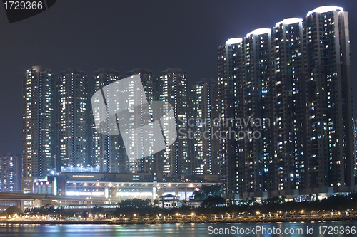 Image of Hong Kong apartment blocks at night, showing the packed conditio
