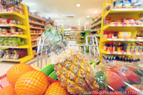 Image of Moving shopping cart in supermarket. It was taken with a slow sh