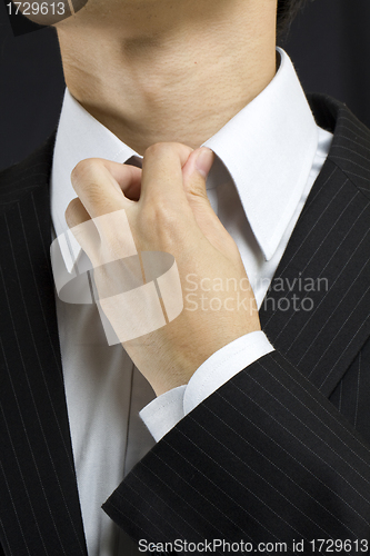 Image of Business man adjusting his suit