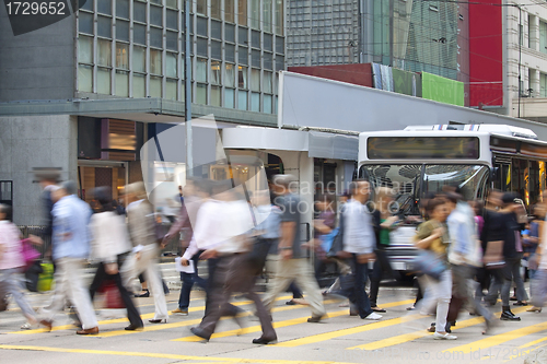 Image of Moving pedestrian in business district, blurred motion.