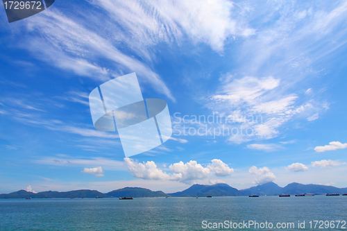 Image of Landscape over the ocean with moving clouds