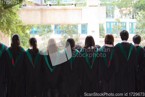 Image of Back of university graduates with their gowns