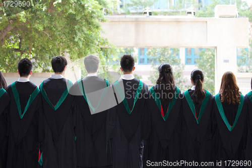 Image of Back of university graduates with their gowns