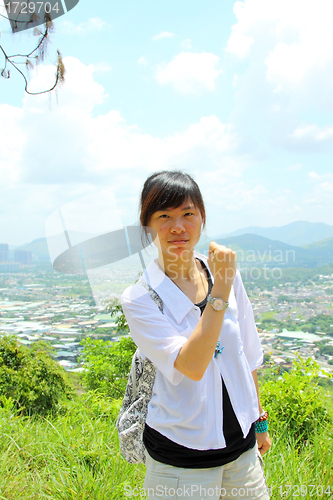 Image of Asian girl hiking in countryside 