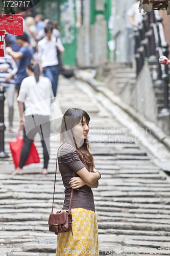 Image of Asian woman waiting alone