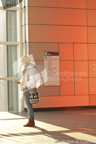 Image of Asian girl in train station waiting someone