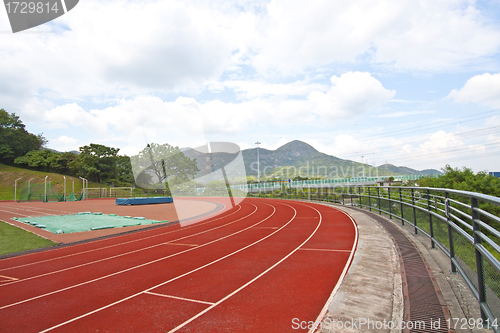 Image of Sports stadium with running track at day