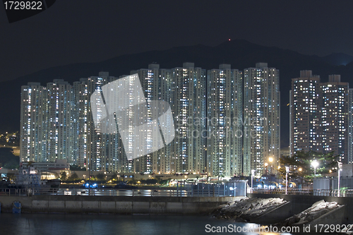 Image of Hong Kong apartment blocks at night, showing the packed conditio