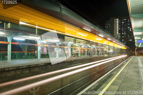 Image of Light rail in Hong Kong at night, busy traffic. 