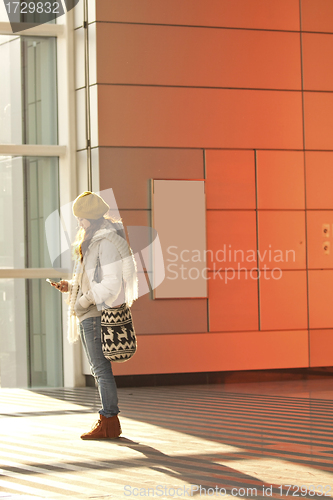 Image of Asian girl in train station waiting someone