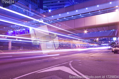 Image of Busy night traffic in business district of modern city