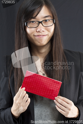 Image of Chinese business woman holding a Chinese red packet and wishing 