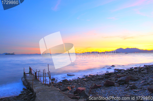 Image of Sunset along the coast with isolated bridge