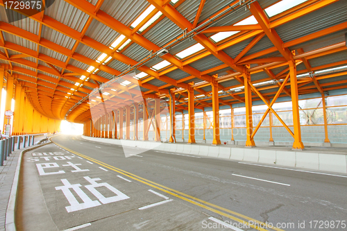 Image of Orange tunnel and highway at day