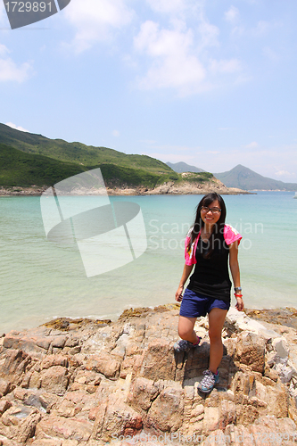 Image of Hiking girl along the coast