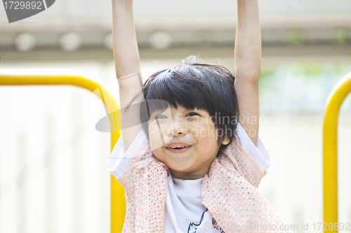 Image of Asian girl playing in park