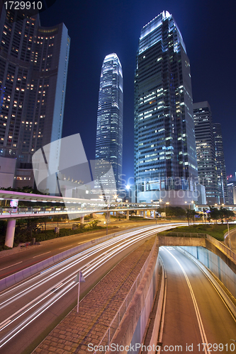 Image of Busy night traffic in business district of modern city