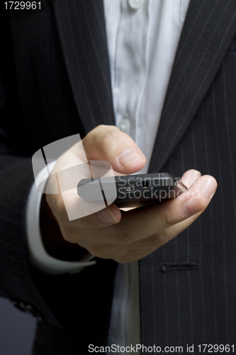 Image of Business man using smart cell phone 