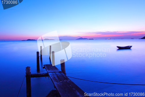 Image of Sunset along a wooden pier at magic hour