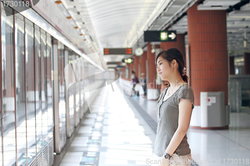 Image of Asian woman waiting for train