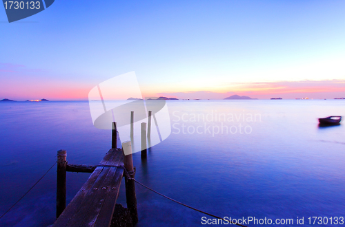 Image of Sunset along a wooden pier at magic hour