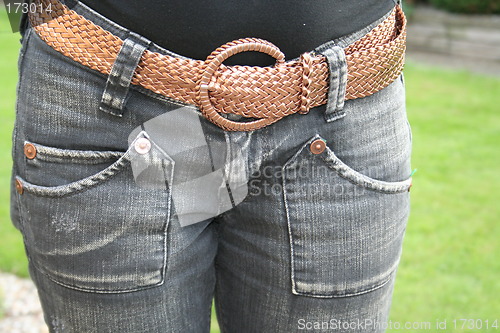 Image of Blue jeans with brown belt