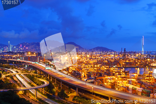 Image of Busy traffic in Hong Kong at night with container terminal backg