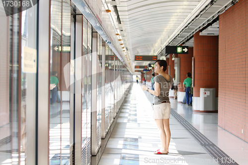 Image of Asian woman waiting for train 