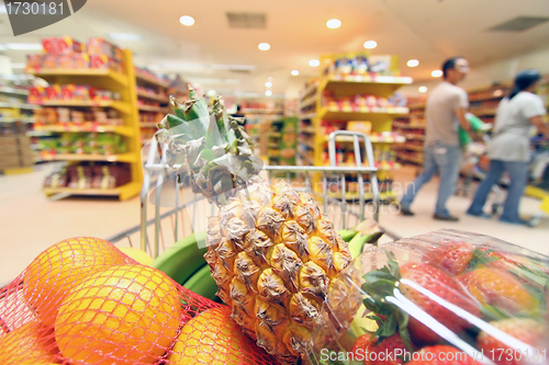 Image of Moving shopping cart in supermarket. It was taken with a slow sh