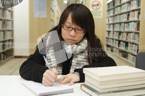 Image of Asian girl studying in library
